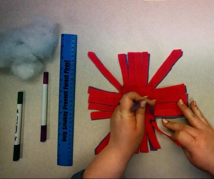 Double knot each diagonal corner strip, tying the top felt piece to the bottom piece.