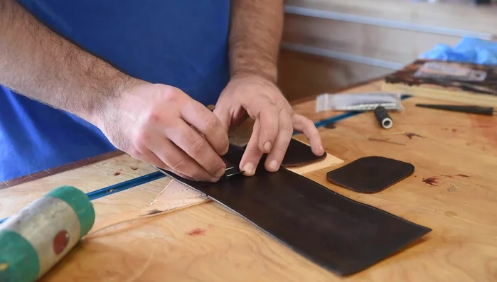 Rivet the belt clip onto the bag before stitching.