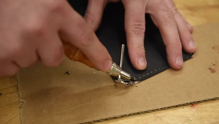 Round off the corners of the flap where the snaps will go.