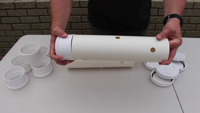 Securely attach the end caps to each end of the PVC pipe. Use a rubber mallet if needed.