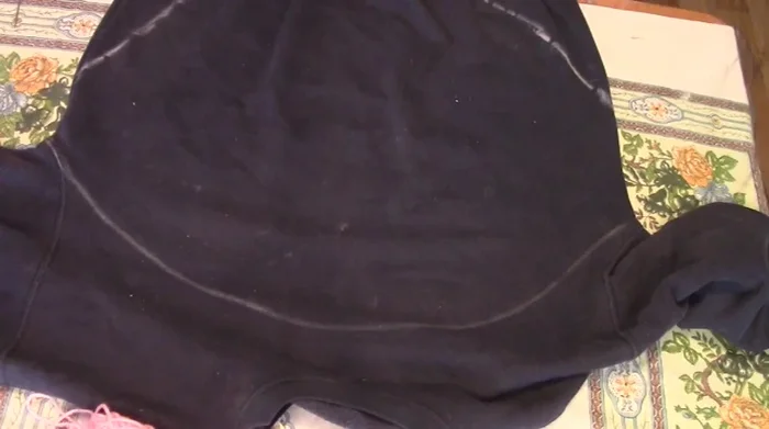 Cut along the bottom chalk line up to the sides. Do not cut along the top chalk line. Cut off the waistband.