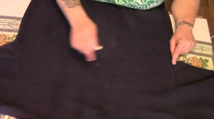 Cut along the bottom chalk line up to the sides. Do not cut along the top chalk line. Cut off the waistband.