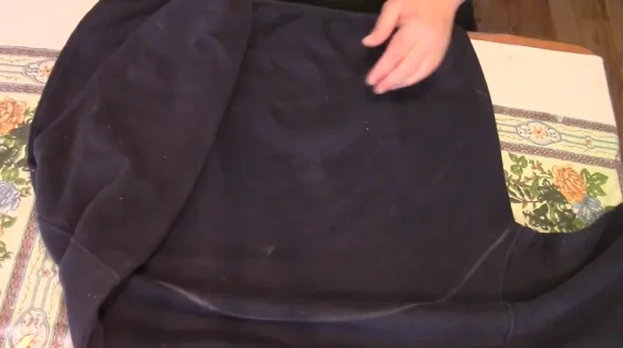 Cut along the bottom chalk line up to the sides. Do not cut along the top chalk line. Cut off the waistband.