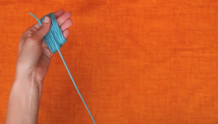 Create the yarn ball: Cut the loops to create a yarn ball.