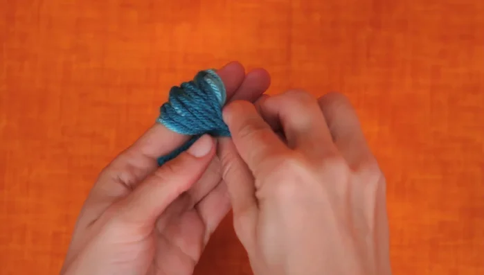 Create the yarn ball: Cut the loops to create a yarn ball.