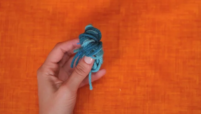 Create the yarn ball: Cut the loops to create a yarn ball.