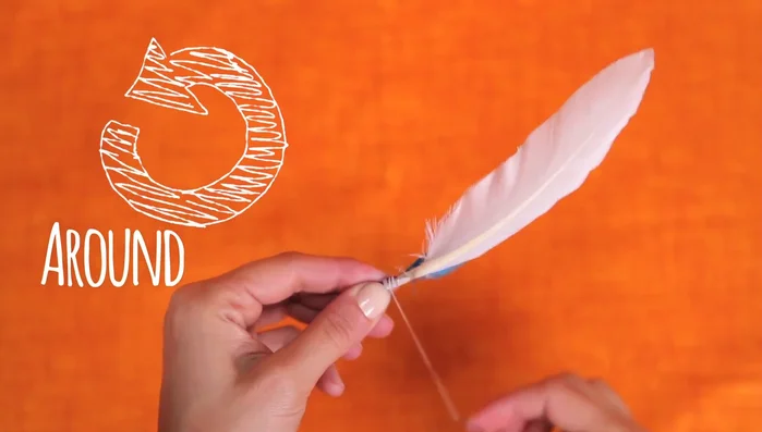 Add the bead: Slide the wooden bead onto the base of the feathers.