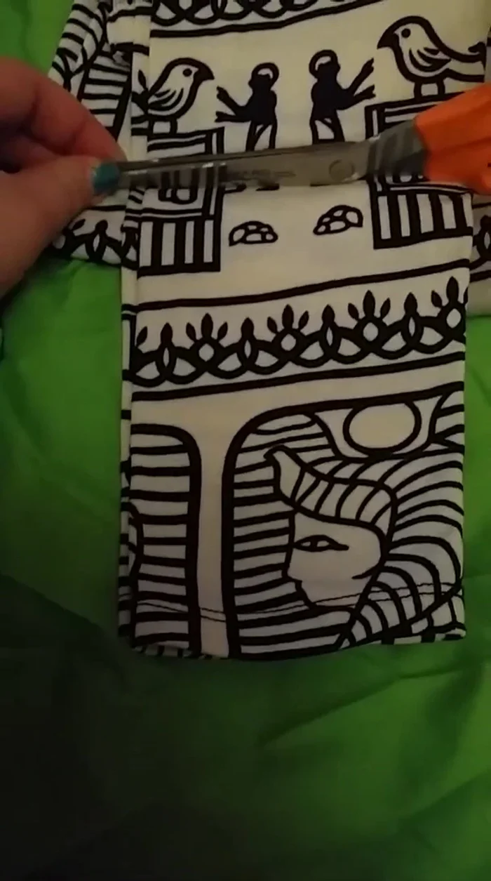 Cut off the excess leggings material from the measured waistline to create the body of the tank top.