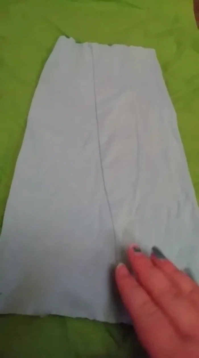 Lay the cut piece of leggings with the seam towards the belly area of the tank top.