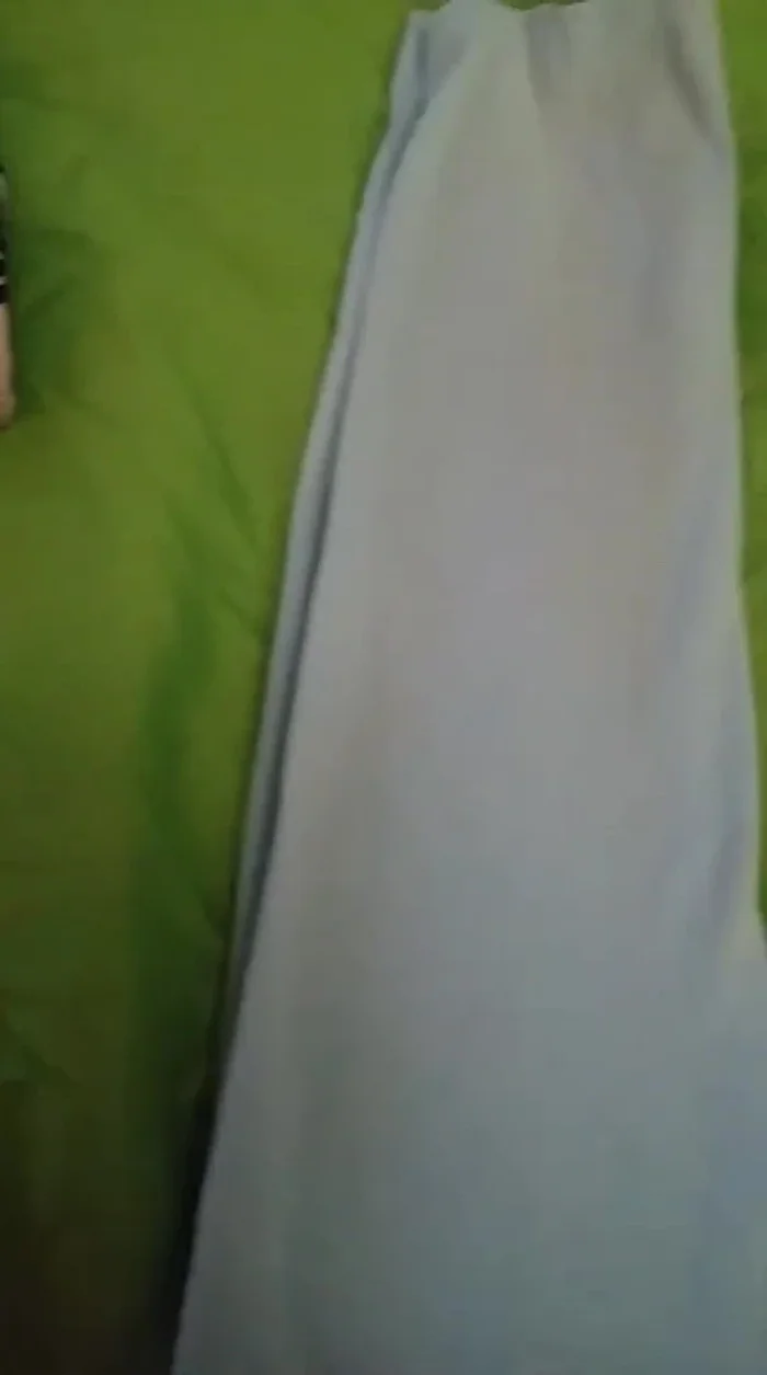 After cutting both sides, you'll have two full circles for the armholes, creating the finished tank top.