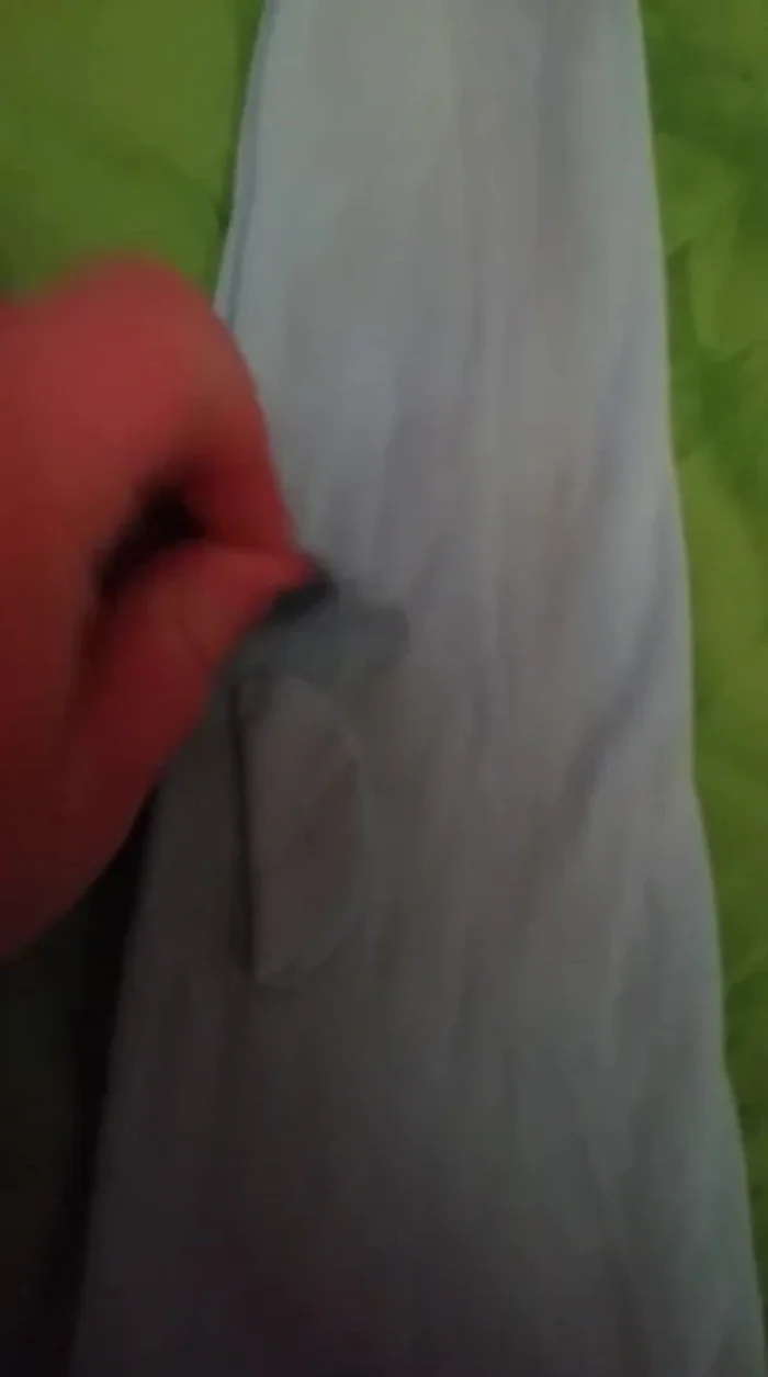 After cutting both sides, you'll have two full circles for the armholes, creating the finished tank top.