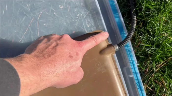 Create a cord slot: Cut a slot in the tub for the heating pad cord to exit the house.