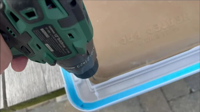 Secure the heated pad: Drill holes in the corners of the heated pad and fasten it to the inside bottom of the tub using wire loops twisted underneath, creating a secure yet removable heating system.