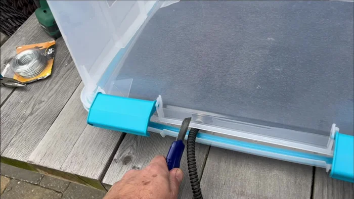 Create a cord slot: Cut a slot in the tub for the heating pad cord to exit the house.