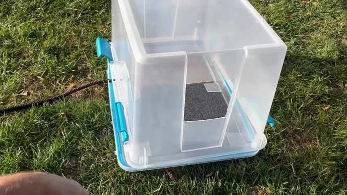 Assemble the cat house: Place the heated pad, foam insulation, and top of the tub on to construct the final product.