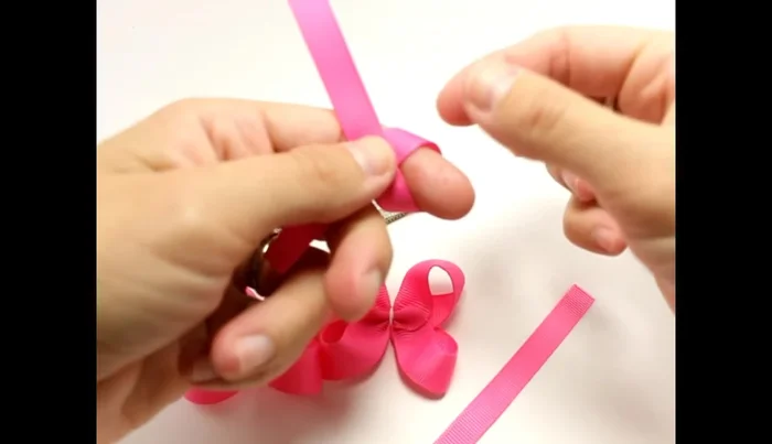 Prepare the small knot: Fold the 3/8 inch ribbon, create a small knot, make two of them and glue them together.