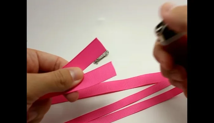 Prepare the ribbon: Fold 5/8 inch ribbon in half and seal the edges with a lighter.