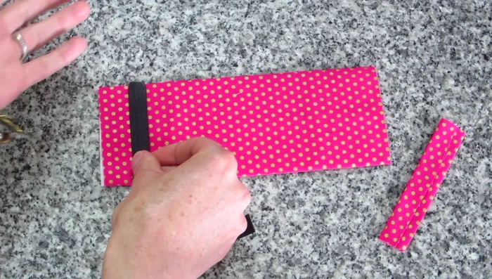 Attach Velcro: Place Velcro 1 inch from the edge of the bow piece on both sides and stitch securely (about three times).