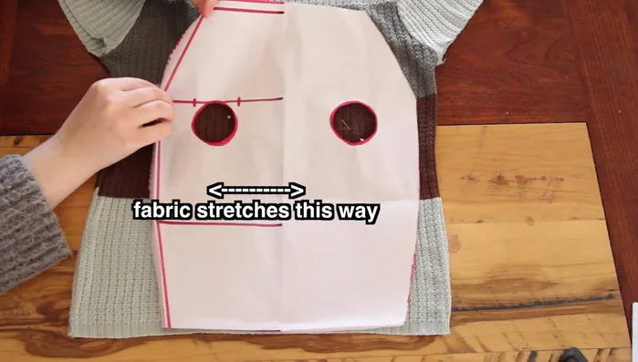 Cut the fabric: Place the pattern onto the stretchy fabric. Use weights to hold the pattern in place; trace around it with pins in and cut out two identical pieces (front and back).