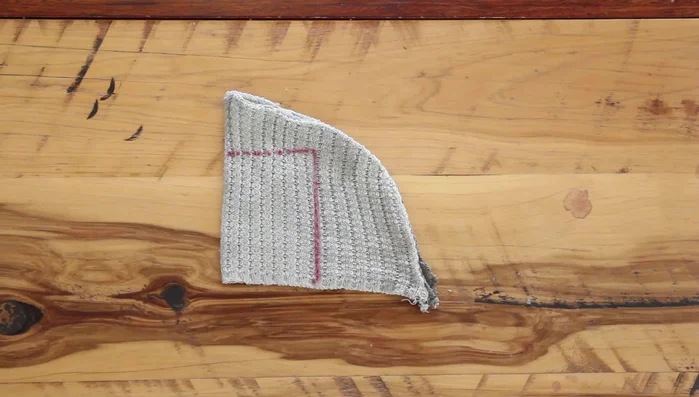 Prepare the sleeves: Cut out rectangles using leftover sweater fabric, making sure it stretches a little longer than your dog's front leg circumference. Fold in half, sew together at edges and turn inside out.