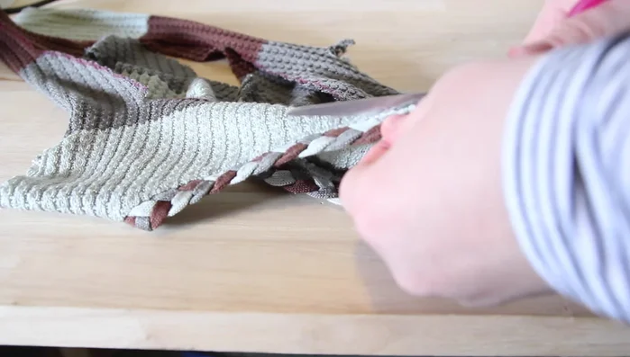 Attach the collar: Sew together the braided collar material, turn right side out and sew it to the neckline of the sweater, stretching as needed.