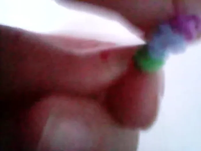 Take the initial base ring (pink), and pull it over the final loop. Carefully remove the toy from the hook.