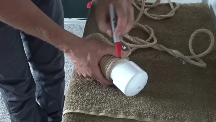 Use a spare cap as a template to determine how far to run the rope. Cut the rope at a slight angle to reduce fraying and secure the end with hot glue.