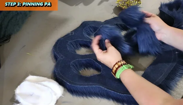 Pin the larger pad to the face of the pillow, tucking in the fur fibers. Pin at key points (top, bottom, sides, corners).