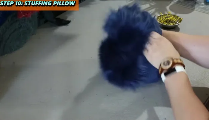 Close the gap with a ladder stitch, pushing the stuffing away from the edges. Comb out any trapped fur fibers.