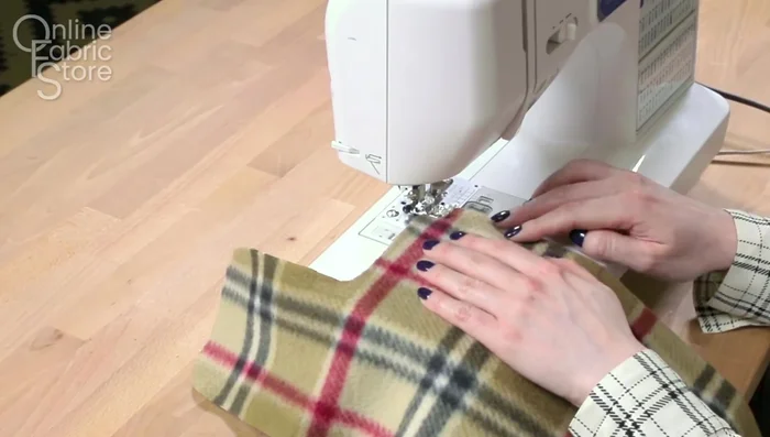 Sew harness opening (if applicable): Sew and open the seam on the nylon layer to create the opening. Repeat on the lining. Prepare and attach a fleece flap with snaps for reinforcement. 