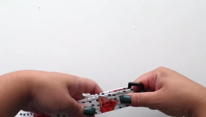 Attach the bolt snap to one end, pulling the strap through about two inches. Sew the strap together to secure the bolt snap, using multiple seams and a cross-stitch for added strength.