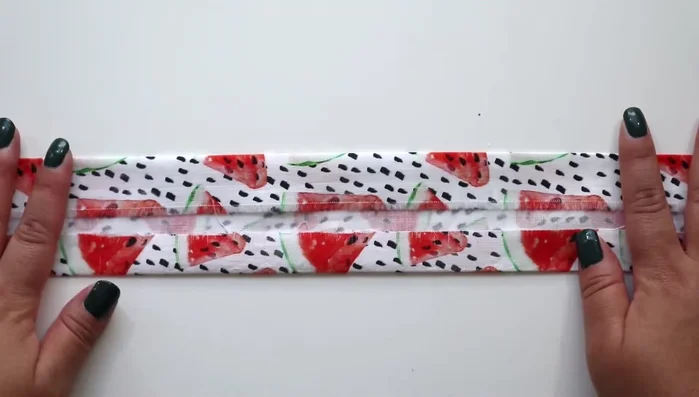 Flip the fabric, press along the basting stitch towards the fold, and remove the basting stitch.