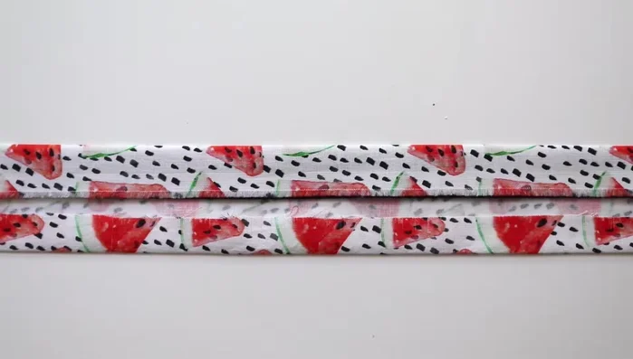 Use binder clips to hold the fabric and strap together. Sew around the entire piece, tucking in the edges at both ends, creating a long rectangle.