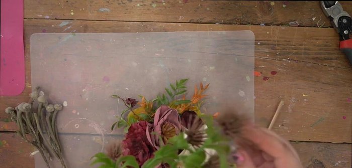 Add smaller greenery and floral details to fill in any remaining gaps and enhance the overall design. Ensure even distribution and visual balance.