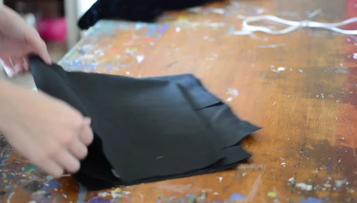 Cut Fabric Pieces: Cut out two wing pieces from both the polyester denim and the velvet fabric, plus two wing pieces from foam for structure.