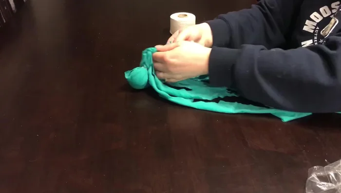 Cut the strips into smaller pieces and braid them together to create 'legs'.