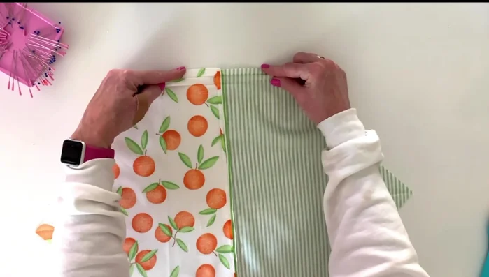 Fold and press the raw edges of both ends of the fabric piece in 1/4 inch twice, then stitch to secure.