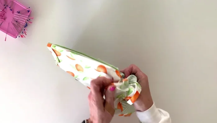 Clip the bottom corners, turn right-side-out, and use a tool to push out the corners to enhance shape.