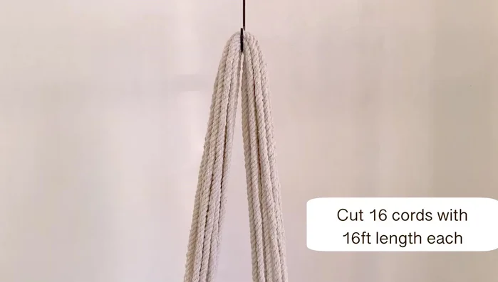 After approximately 8 inches of square knots, find the middle of the cords again and attach them to the S-hook.