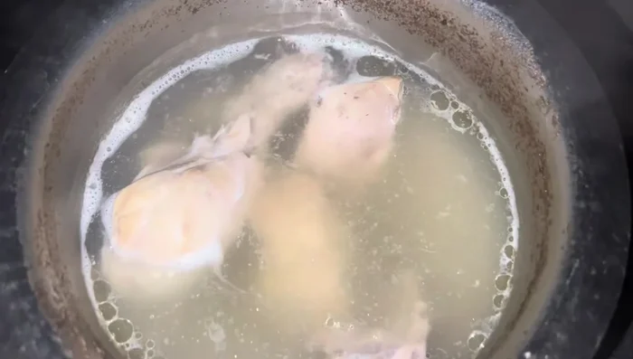 Simmer the chicken on low heat for approximately 1.5 hours to allow the broth to extract maximum nutrients and oil from the bones.