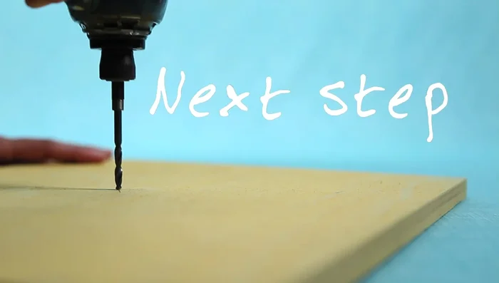 Drill a hole in the center of the plywood base and another hole 1 inch deep in the end of the dowel.