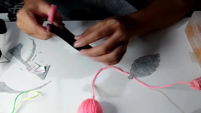 Cut and shape felt leaves, ensuring a small uncut portion at the stem to hold them together.