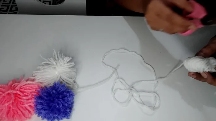 You can attach the pom-poms to a stick or place them separately in a cat bed.