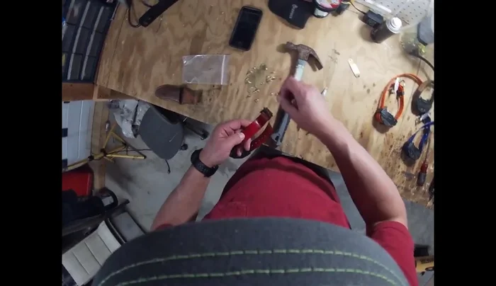 Using a hammer and potentially pliers, firmly secure the rivet by flattening it on the underside of the collar. Ensure the name and phone number are facing outwards.