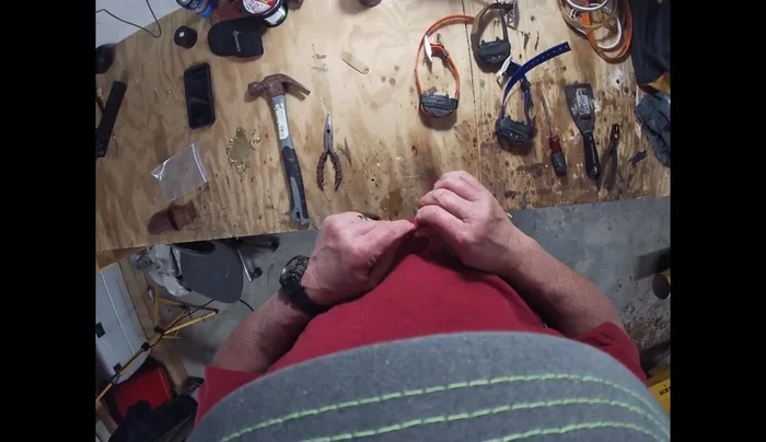 Using a hammer and potentially pliers, firmly secure the rivet by flattening it on the underside of the collar. Ensure the name and phone number are facing outwards.