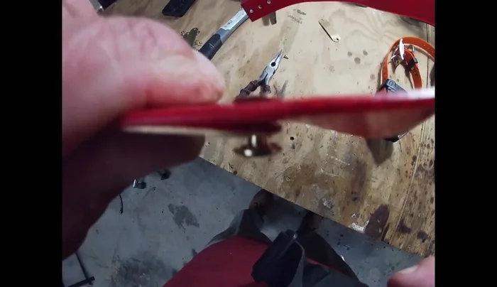 Using a hammer and potentially pliers, firmly secure the rivet by flattening it on the underside of the collar. Ensure the name and phone number are facing outwards.