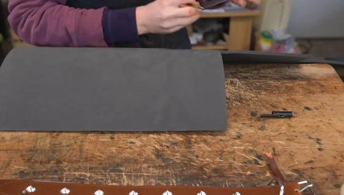 Prepare and attach padding: Measure and cut foam padding, taper the ends, and glue to the lining.