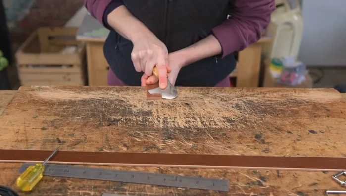 Prepare the d-ring: Skive two leather wedges to cover the raw ends near the d-ring.