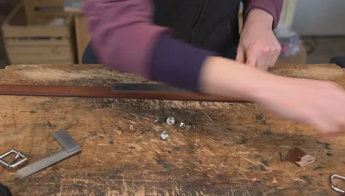 Prepare for studs: Mark and split the leather to accommodate the stud legs.