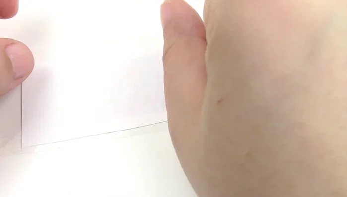 Create catnip snack packages using self-seal bags, tape, and decorative paper. Cut out the snack shapes and seal the bags.